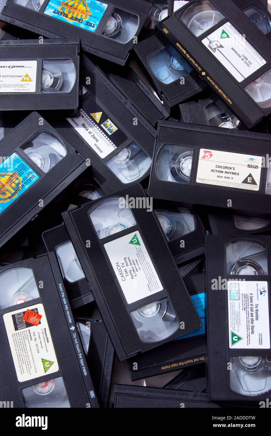 Pile of children's video tape cassettes being prepared for disposal and recycling Stock Photo