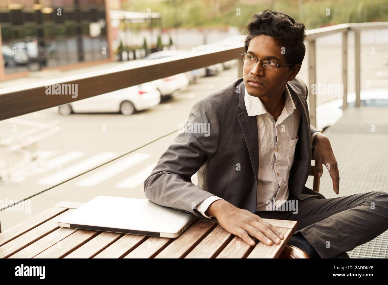 Young handsome man is sitting at the table Stock Photo
