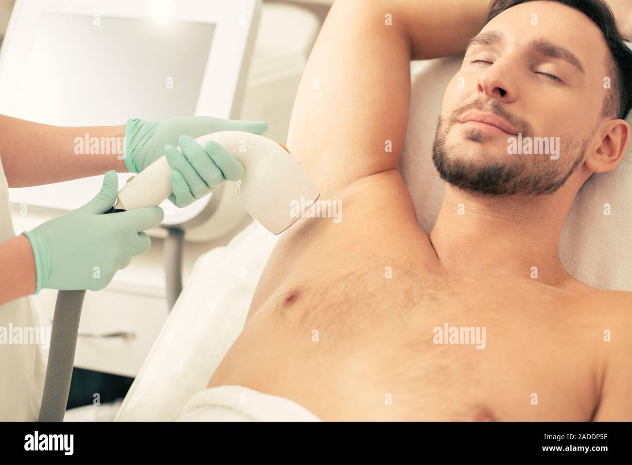 Bearded Man Relaxing At The Laser Hair Removal Procedure Stock