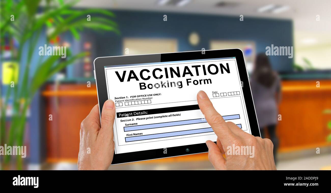 Patient completing a Vaccination booking form on computer tablet - technology concept Stock Photo