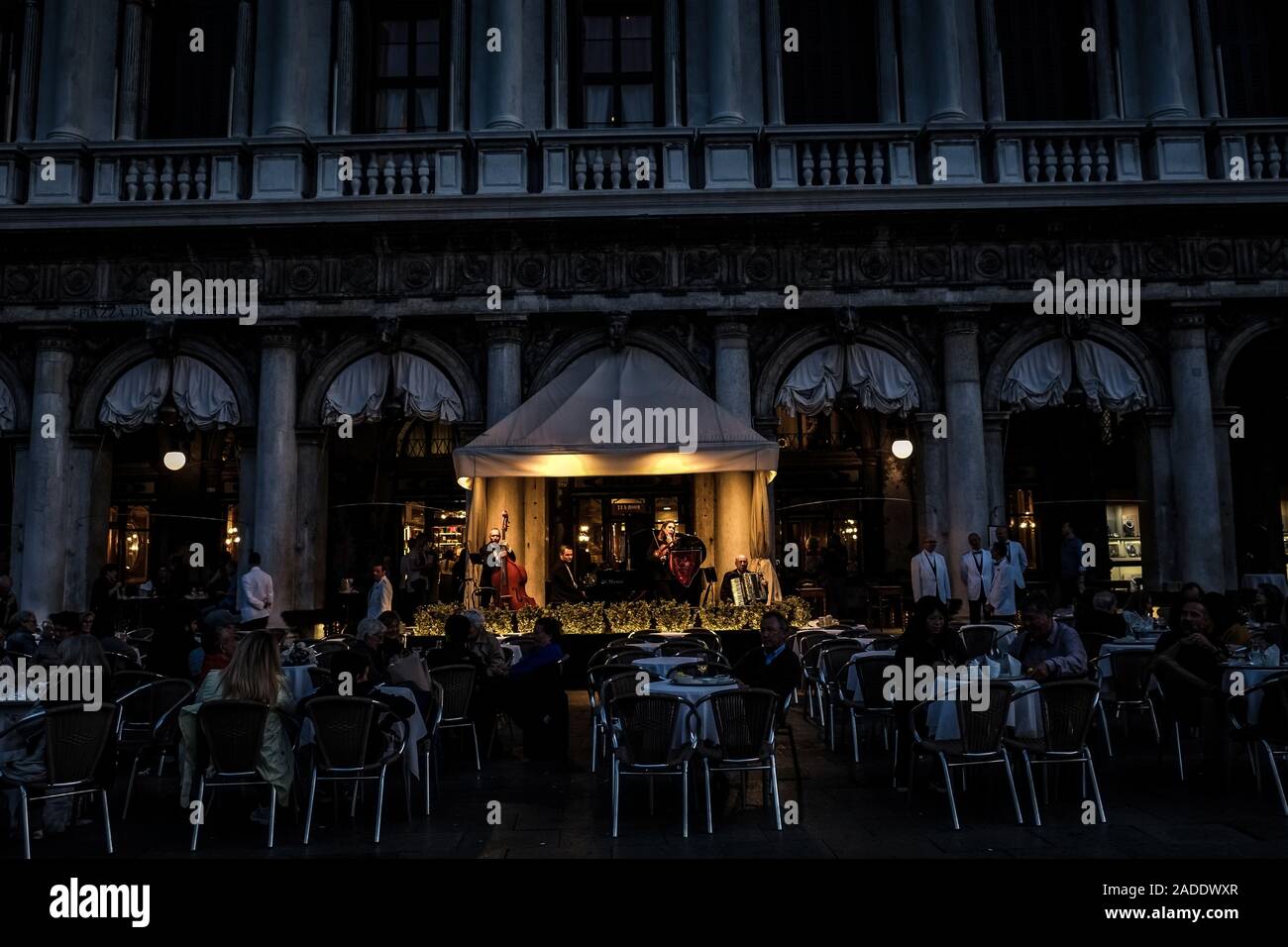 Musician in front of Cafe Florian on St Mark's Square in Venice. Stock Photo