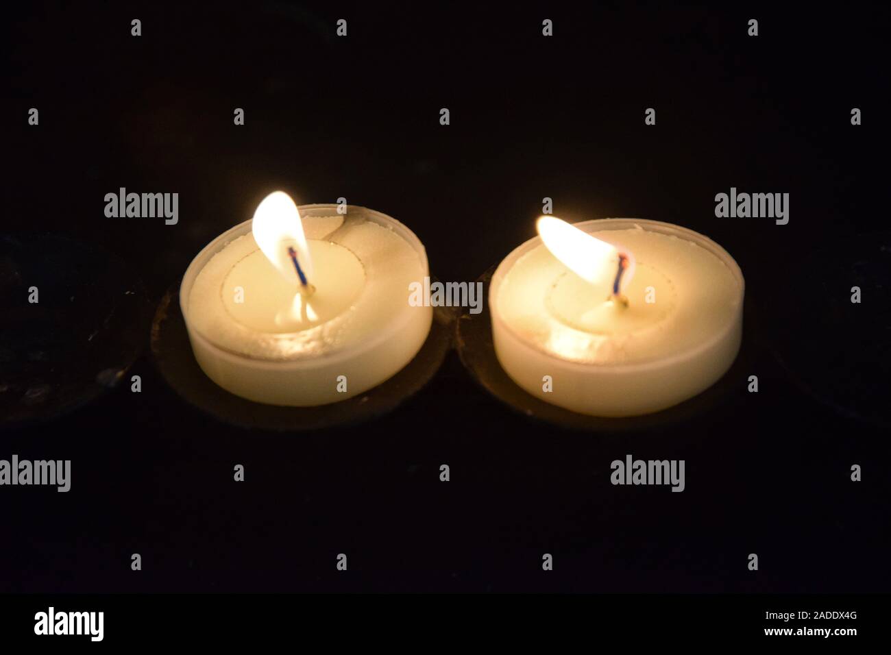 votive candles alight Stock Photo