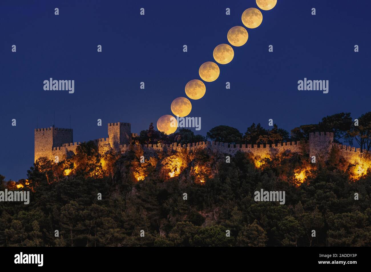 Harvest Moon over castle, time-lapse image. The September Full Moon is ...