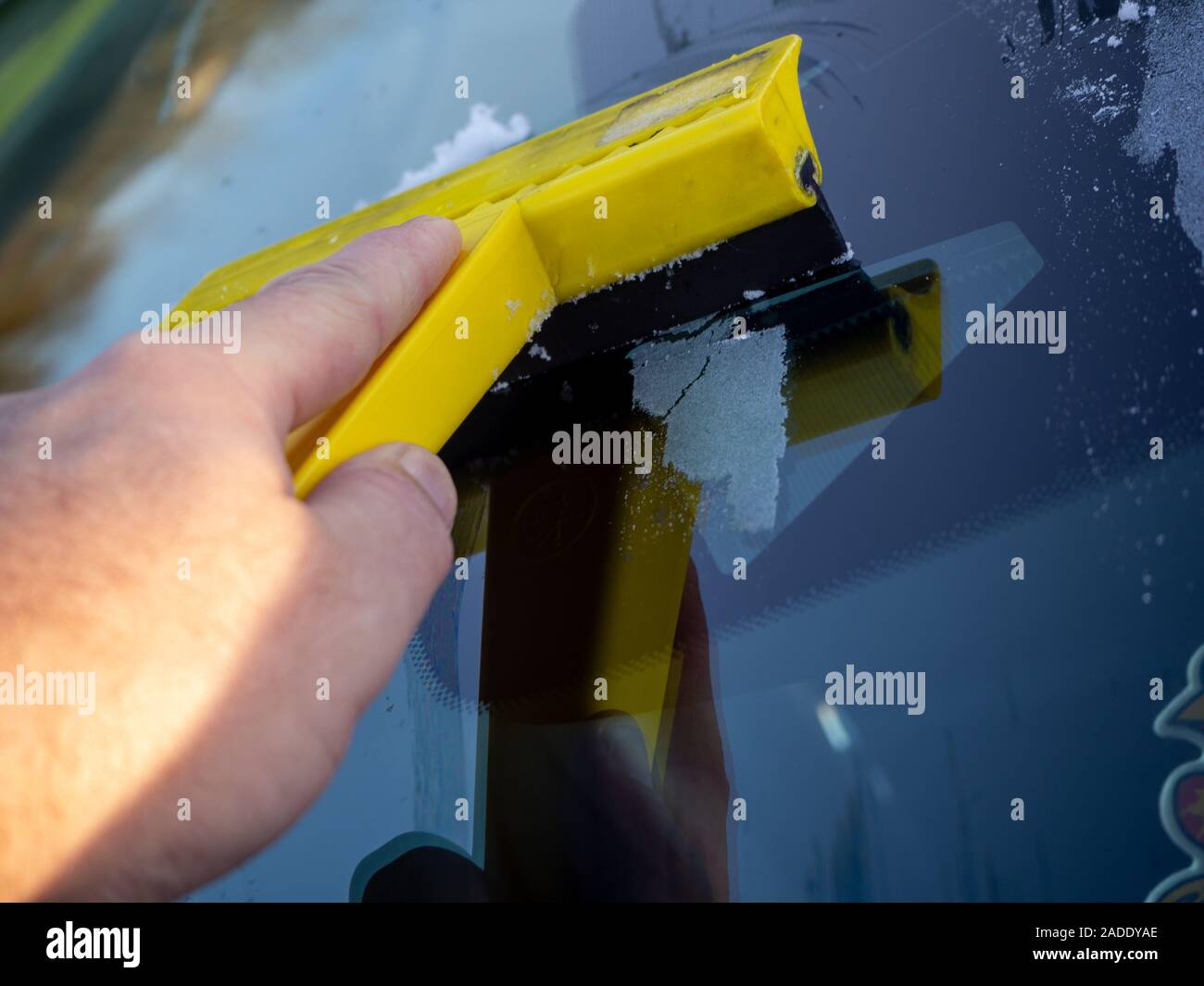 winter driving - scraping ice from a windshield taken on a cold frosty morning Stock Photo