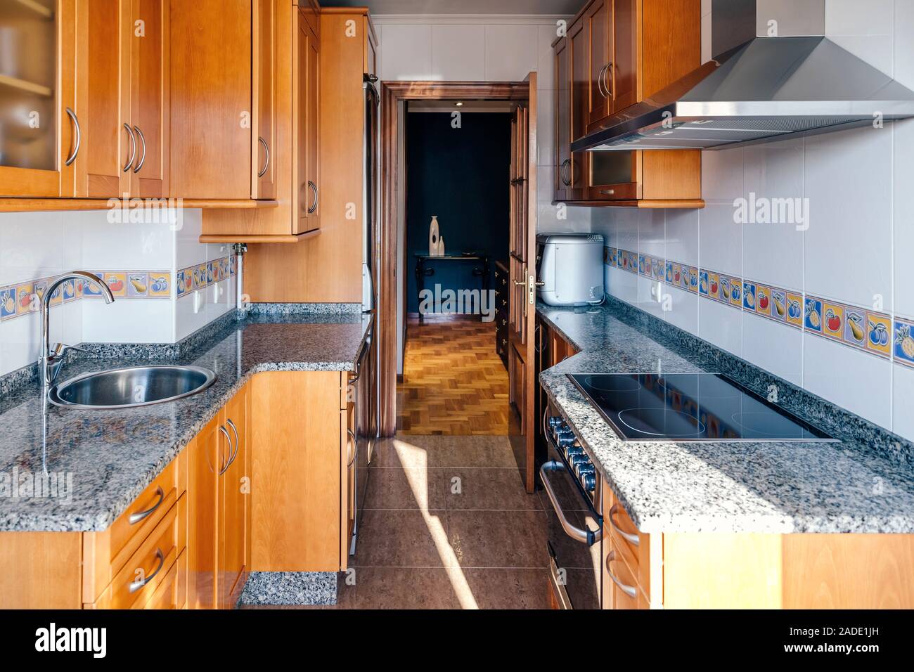 Kitchen on two fronts with wooden furniture Stock Photo