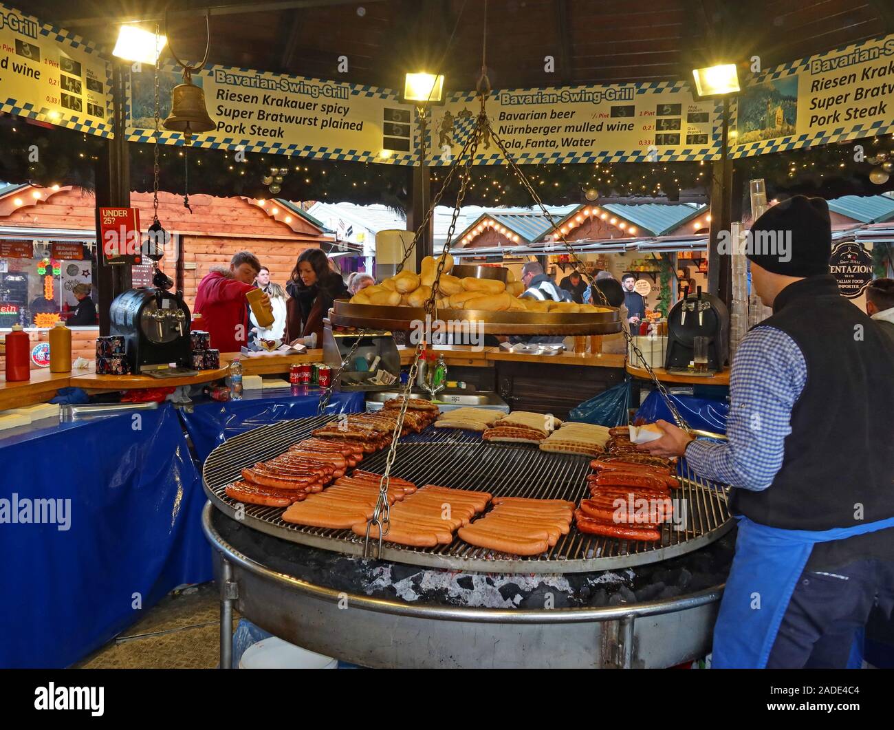 Bavarian Swing Grill,sausages,Wurst,bratwurst,currywurst,grilling over charcoals,German market,Christmas market, Albert Square,Manchester,England,UK, Stock Photo
