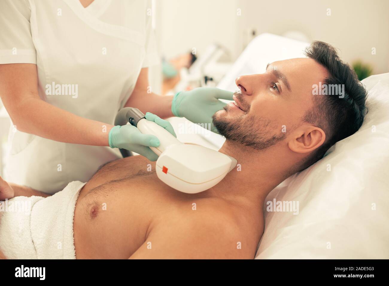 Laser Hair Removal Process On The Neck Of Confident Man Stock