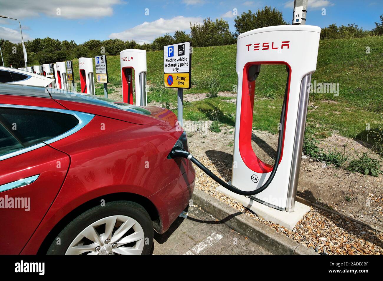 Recharging an electric car at a recharging point provided by Tesla