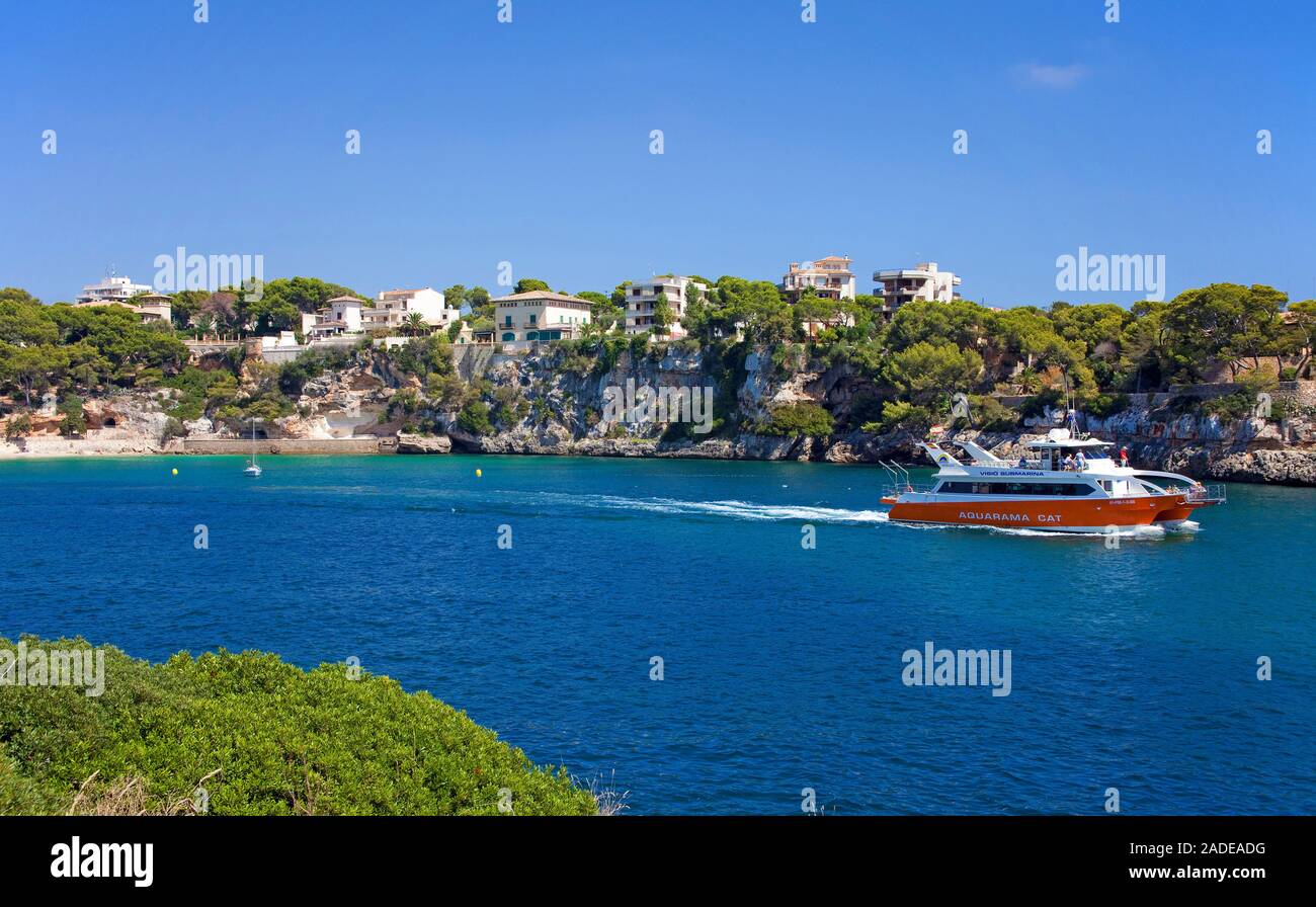 Excursion boat leaving the harbour of Porto Christo, Mallorca, Balearic islands, Spain Stock Photo