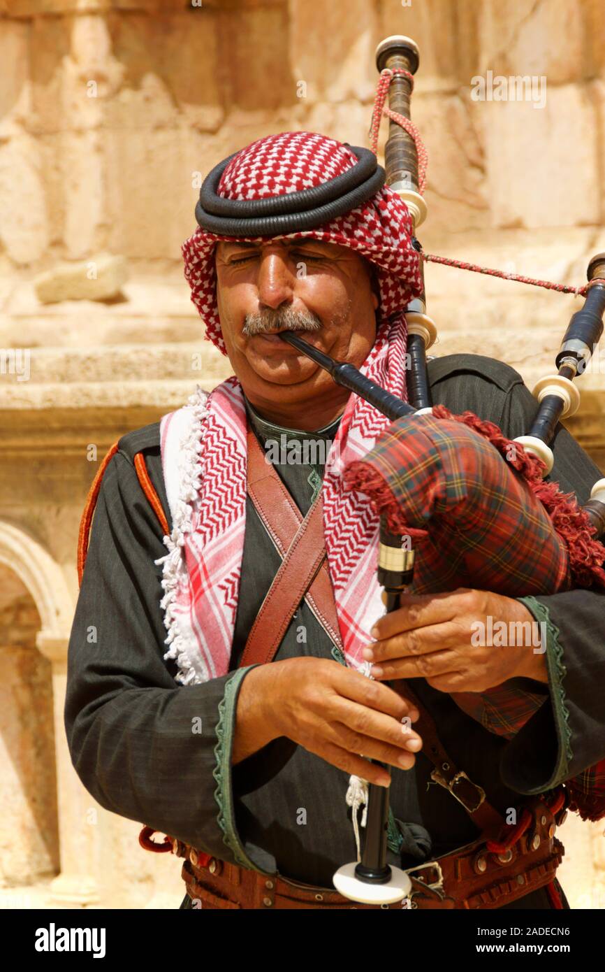 Jerash, Jordan - May 1, 2018: Jordanian bagpipe player in the roman theatre of the archeological site of Jerash near Amman in Jordan. Only one person. Stock Photo