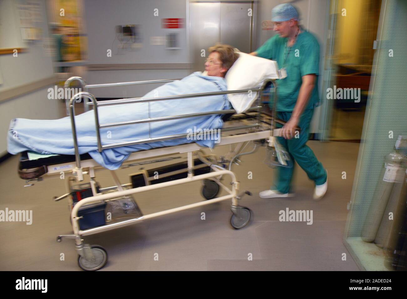 Operating Department Practitioner wheeling patient through to Operating ...