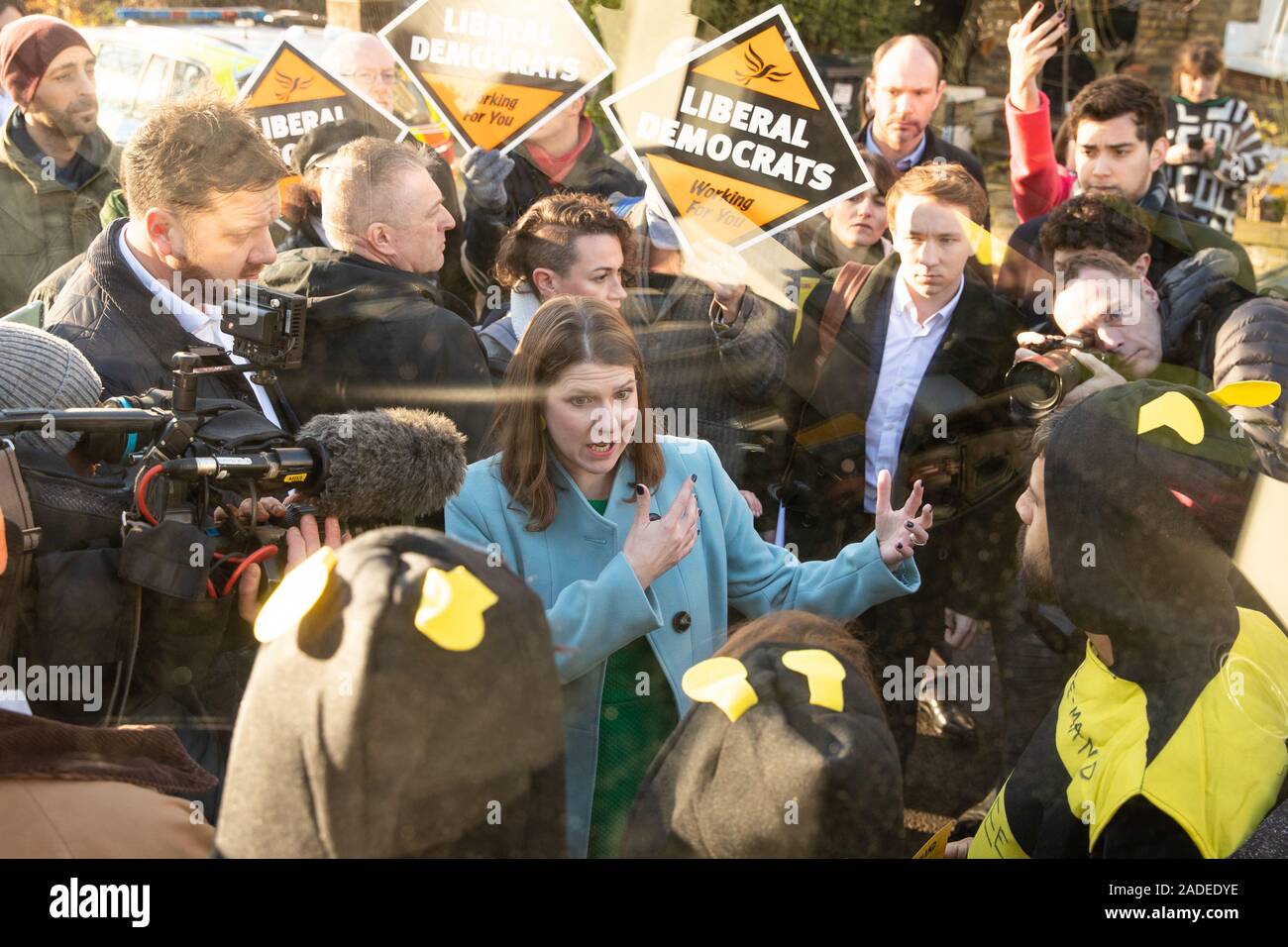 Liberal Democrat leader Jo Swinson speaks to Extinction Rebellion protesters dressed as bees after they glued themselves to the party's battle bus during a visit to Knights Youth Centre in London, while on the General Election campaign trail.. Stock Photo