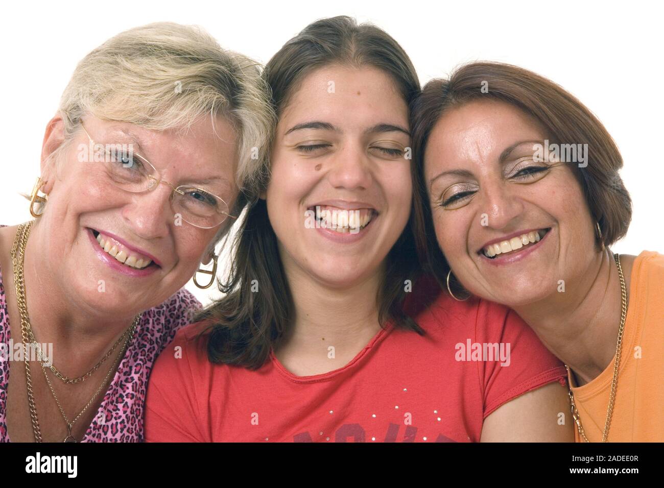 Three women, heads together, smiling. Stock Photo