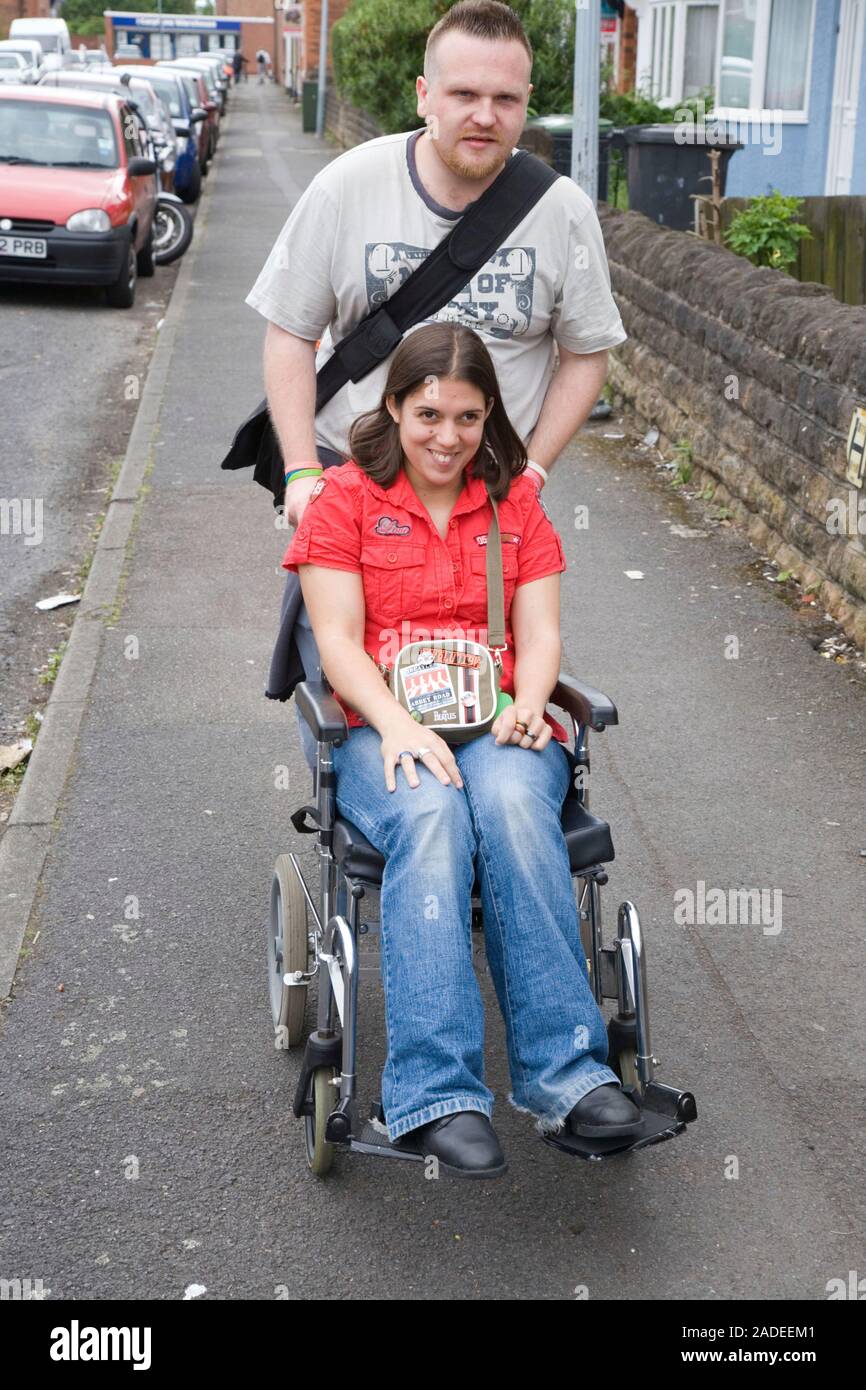 Young woman with cerebral palsy in a wheelchair with her boyfriend ...