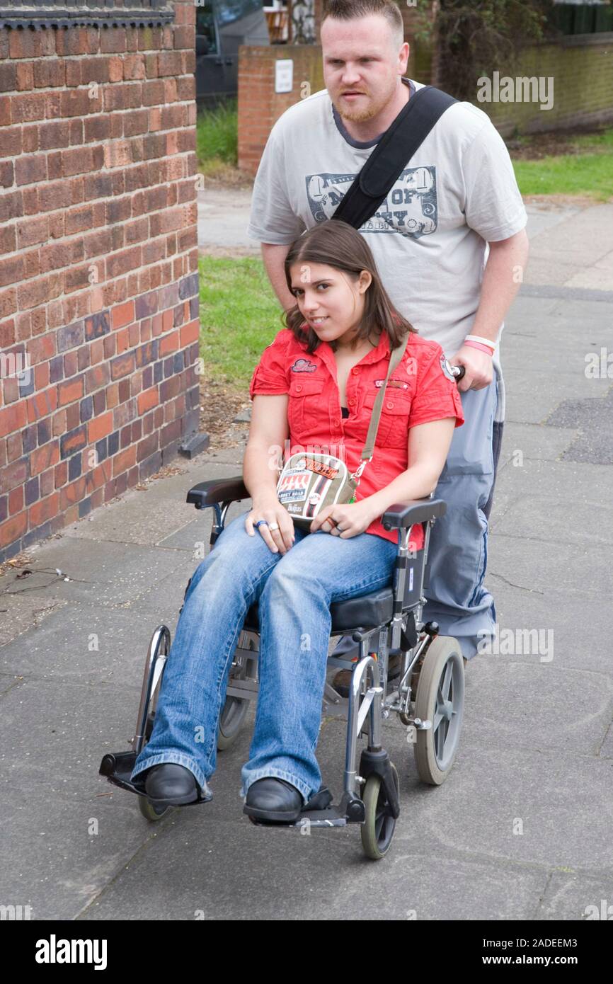 Young woman with cerebral palsy in a wheelchair with her boyfriend ...