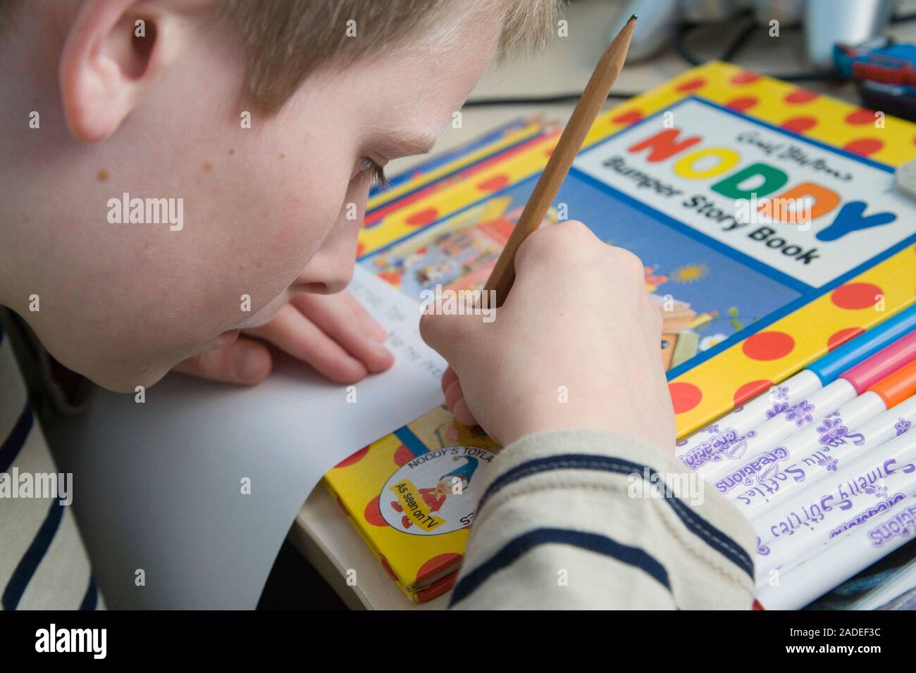 Boy with autism practicing writing Stock Photo - Alamy