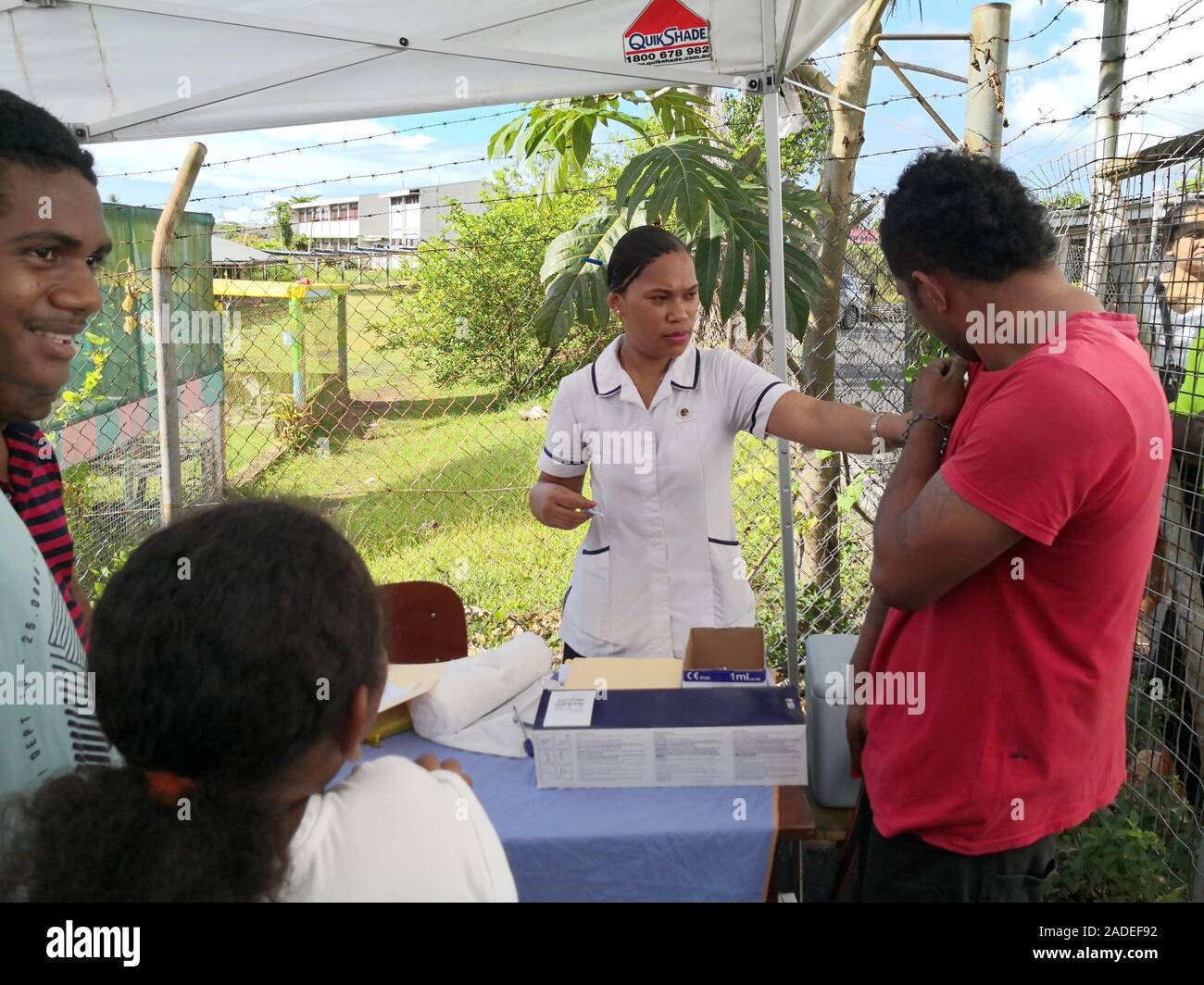 Suva, Fiji. 4th Dec, 2019. A resident receives measles vaccine in Suva, Fiji, Dec. 4, 2019. The second phase of the measles immunization campaign began on Wednesday in Fiji's capital Suva. The immunization campaign targets children who have not received two doses of the measles vaccine, any child aged 12 and 18 months who is due for immunization, people travelling overseas, healthcare workers, and airport and hotel staff around the country. There are 15 confirmed measles cases in Fiji by Tuesday. Credit: Zhang Yongxing/Xinhua/Alamy Live News Stock Photo