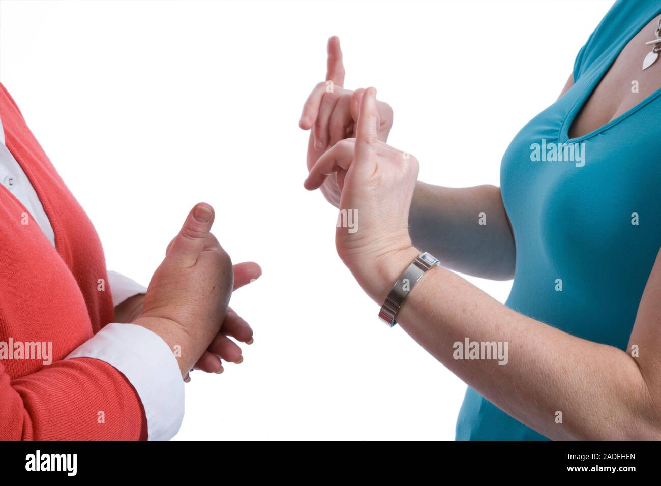Two women using sign language to communicate. Stock Photo