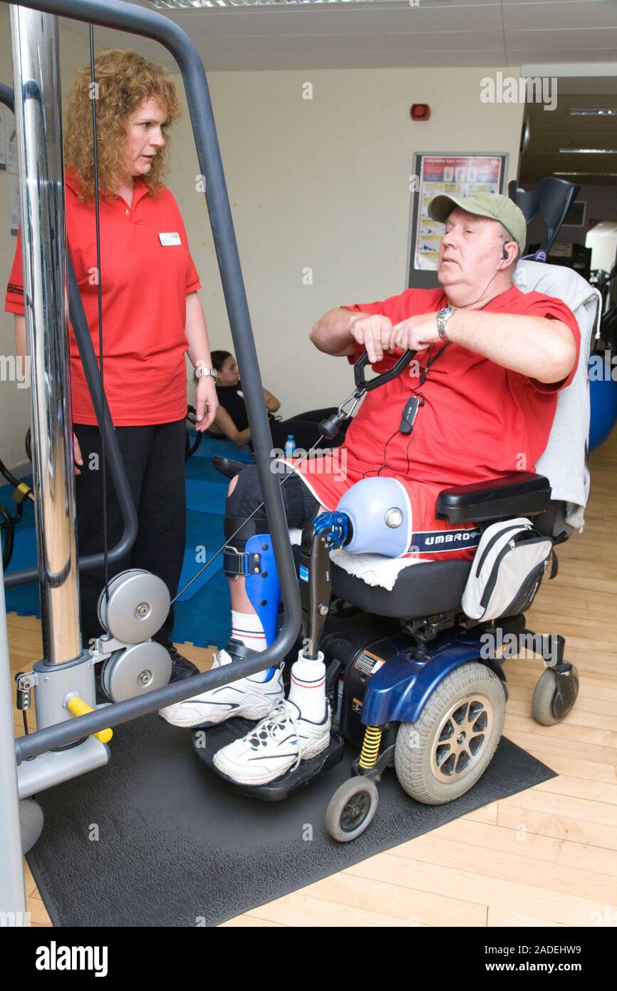Man with prosthetic limb using pulley machine at a gym. Stock Photo