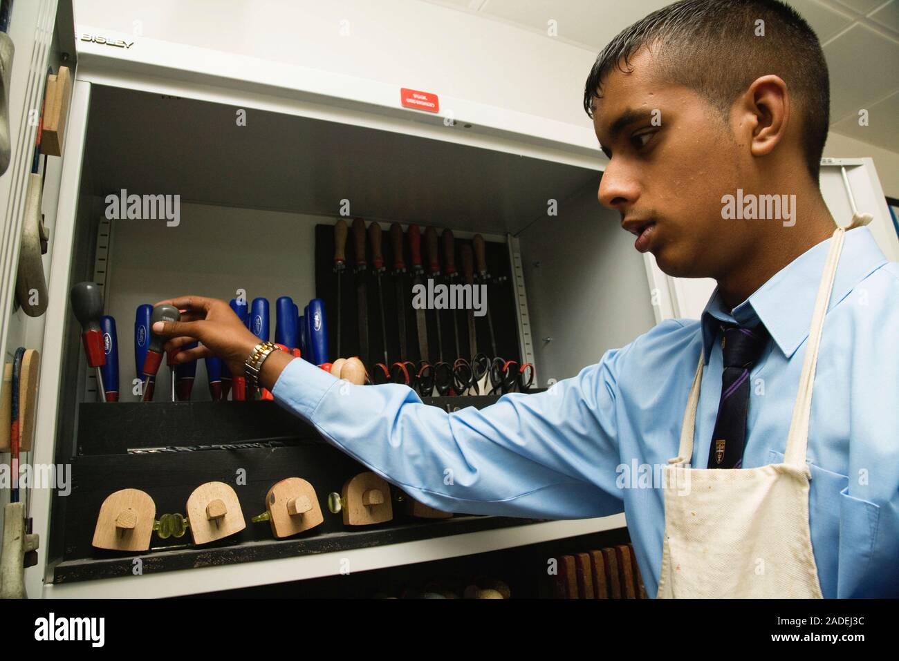 Secondary school student selecting tools to use in a woodwork lesson