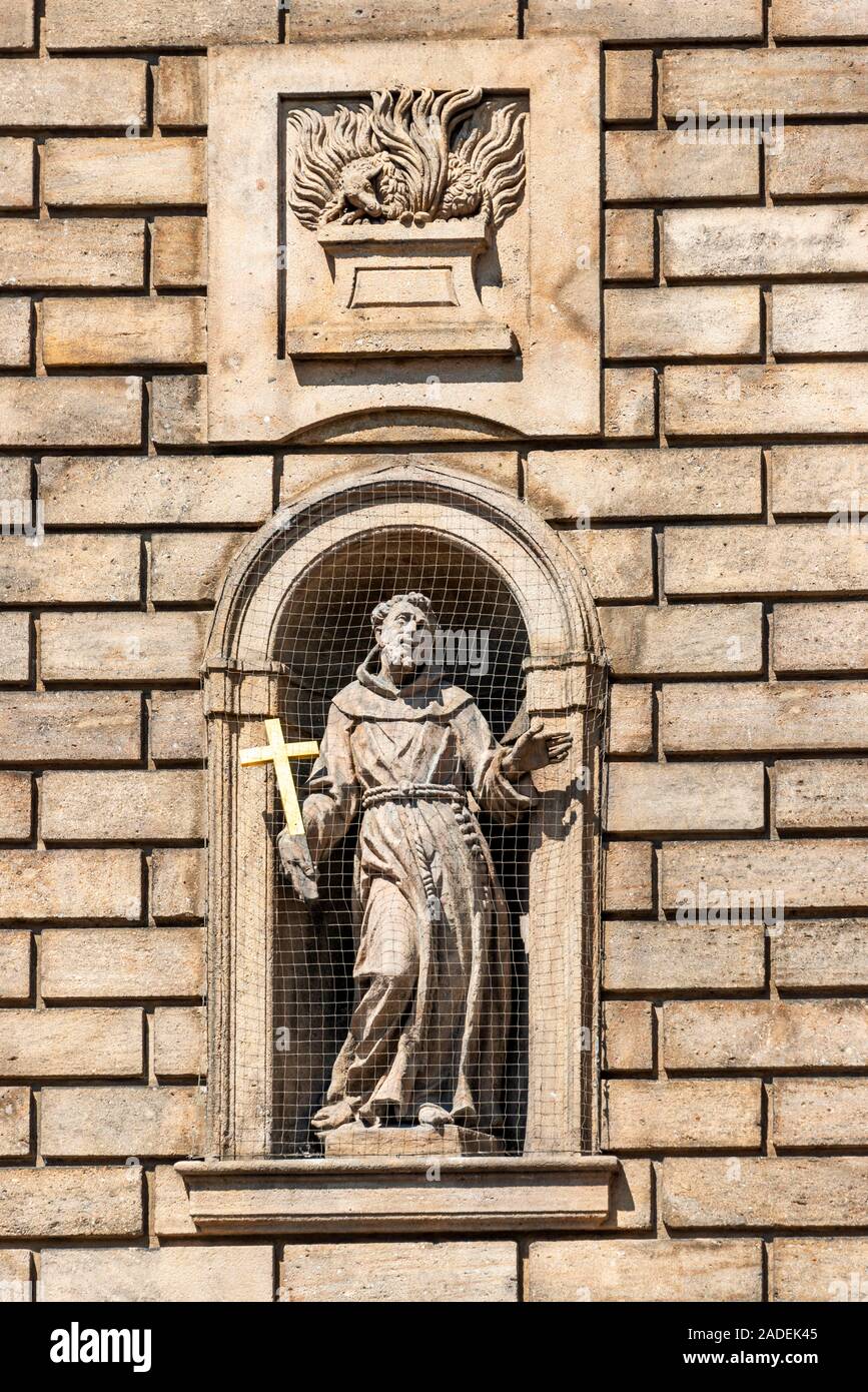 Statue of St. Francis of Assisi in a niche on the facade of the Church of the Knights of the Cross, Old Town, Prague Stock Photo