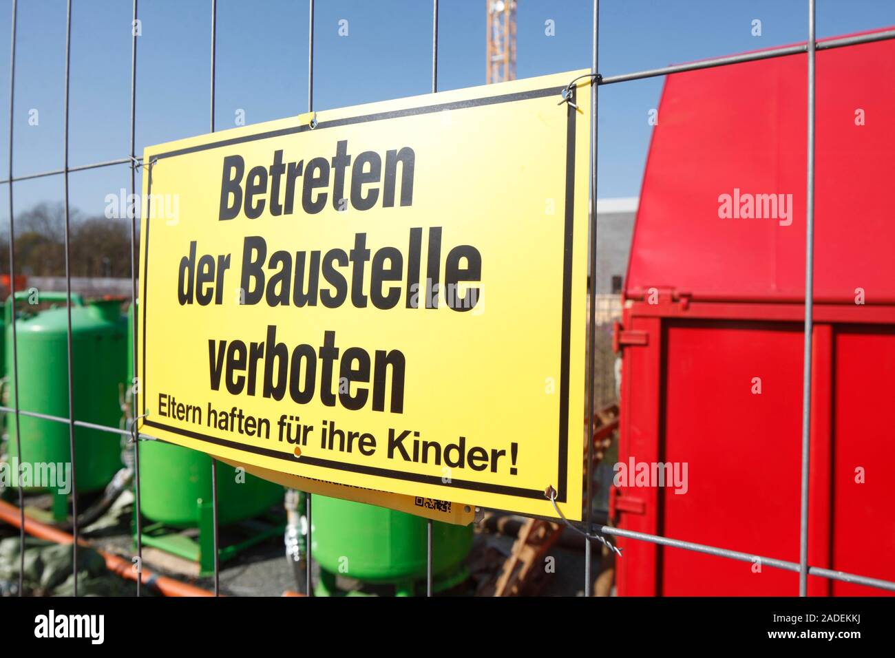 Yellow sign: No one is allowed to enter the building site on a metal grid, Germany Stock Photo