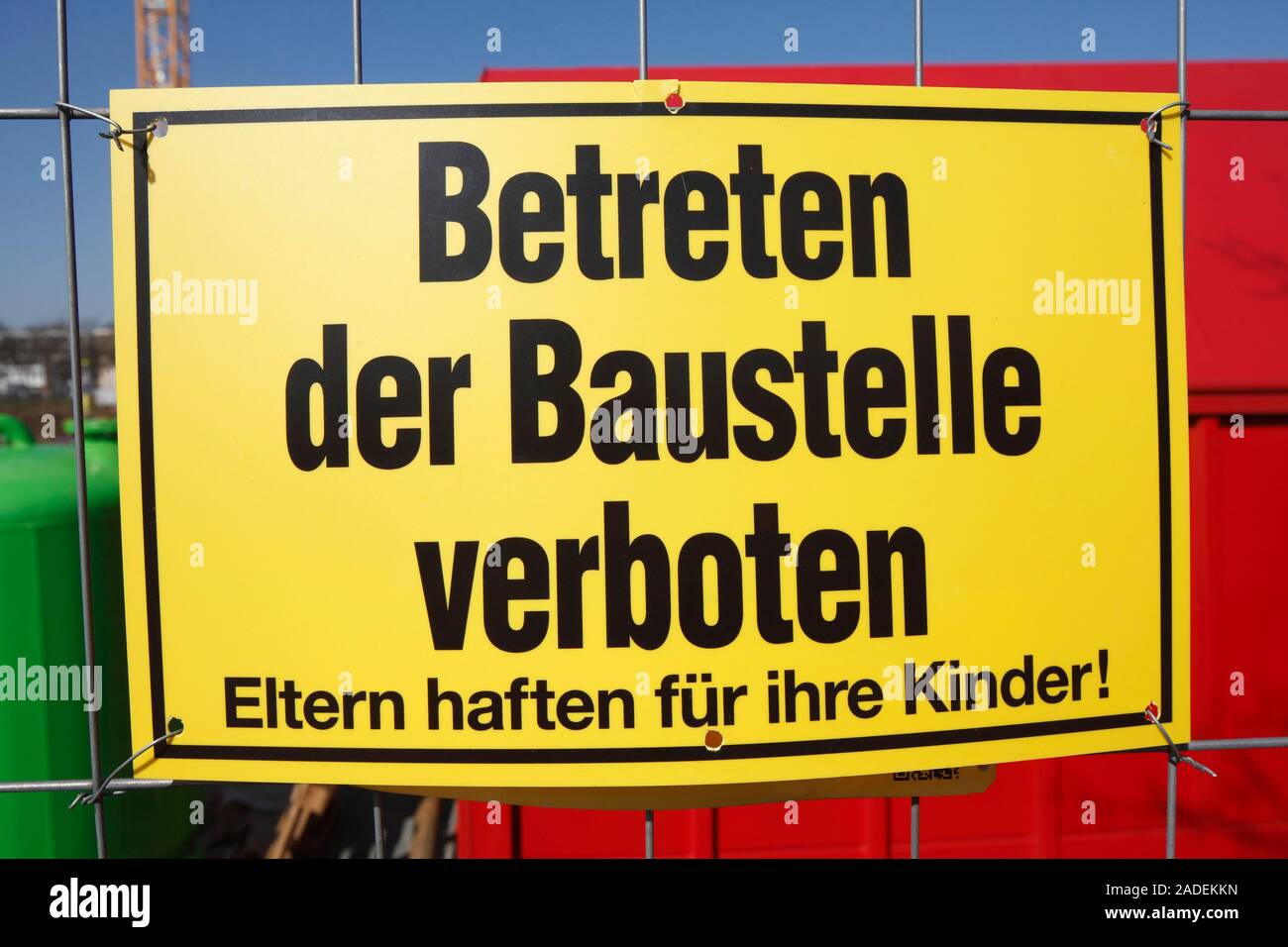 Yellow sign: No one is allowed to enter the building site on a metal grid, Germany Stock Photo