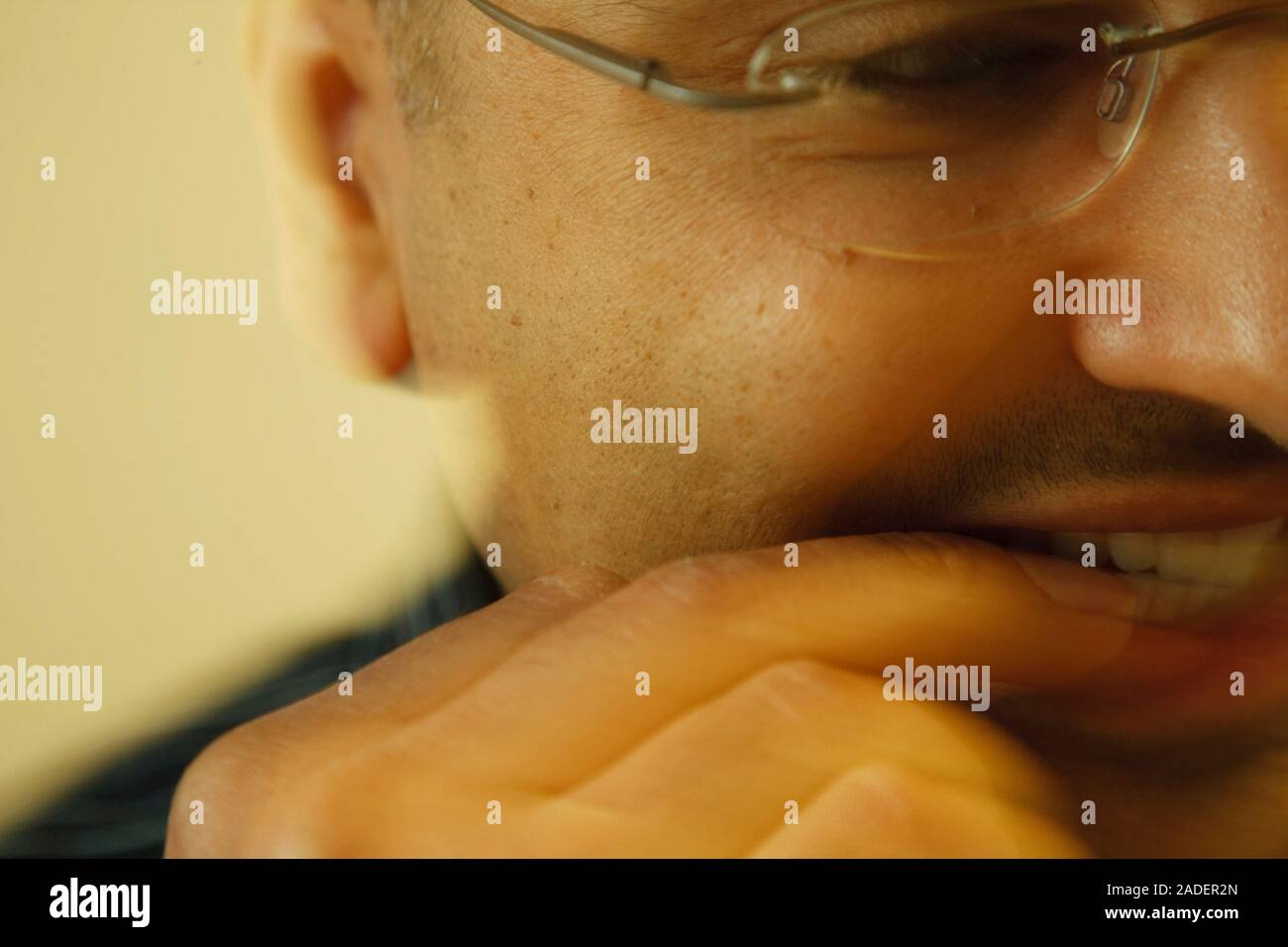 Worried person biting their nails. Stock Photo