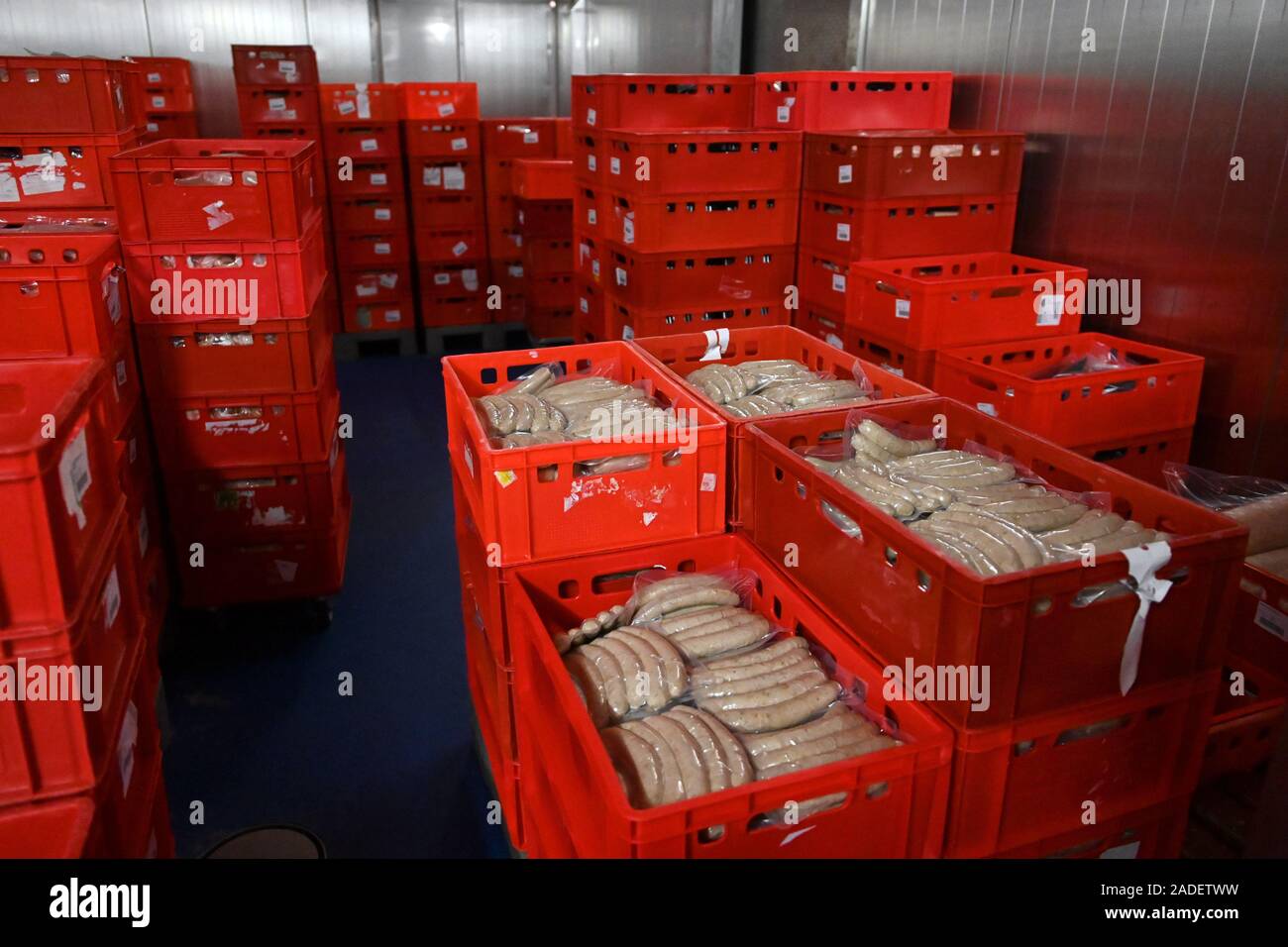 Usseln, Germany. 03rd Dec, 2019. Meat products are stacked in red boxes in the cold store of 'Upländer Feinkost Waldecker Fleischwaren Heinrich Saure GmbH'. Saure has 30 employees and produces 80 tons of sausage and meat specialities per month. (zu dpa-Korr 'Wilke meat scandal: Consumers do not spoil their appetite') Credit: Uwe Zucchi/dpa/Alamy Live News Stock Photo