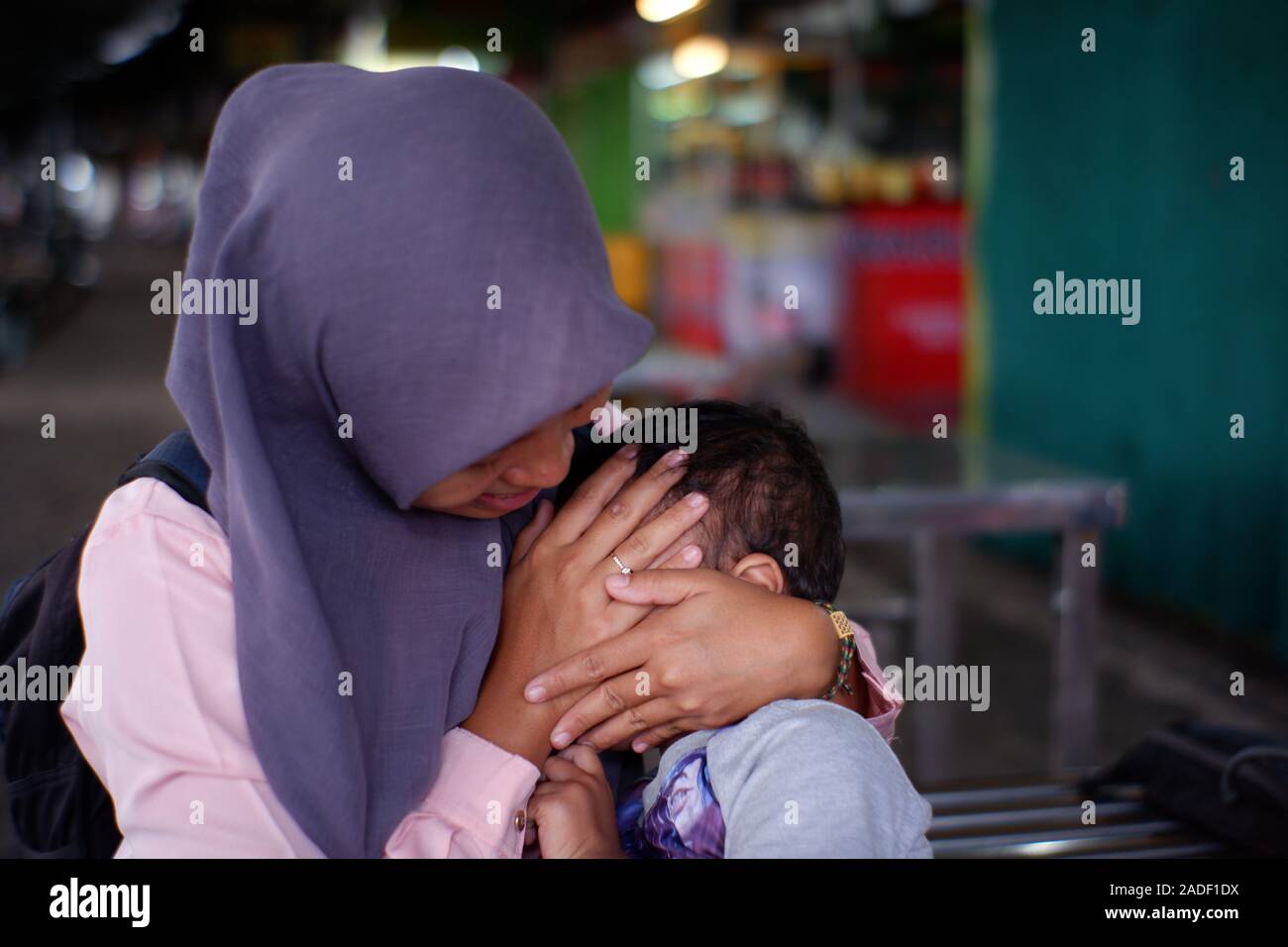 A child rejected to have camera shots so after then he needed his mother hands to cover the face. Because he is very shy kid. Stock Photo