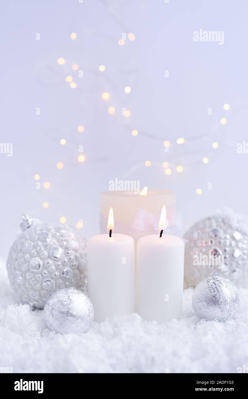 Christmas candles on the snow and Christmas lights. Festive Christmas  background Stock Photo - Alamy