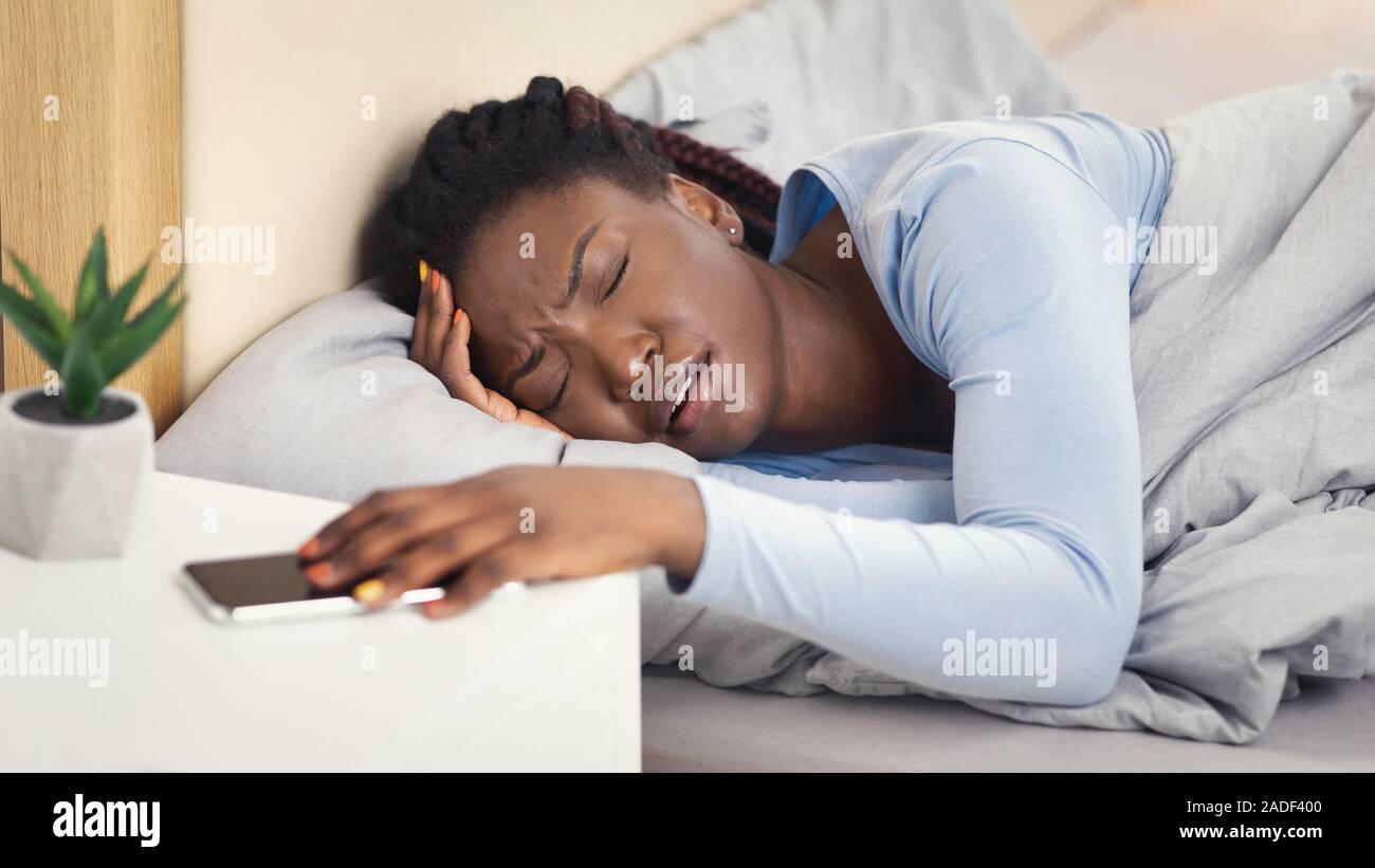 Lady Having Headache Turning Off AlarmClock Lying In Bedroom, Panorama