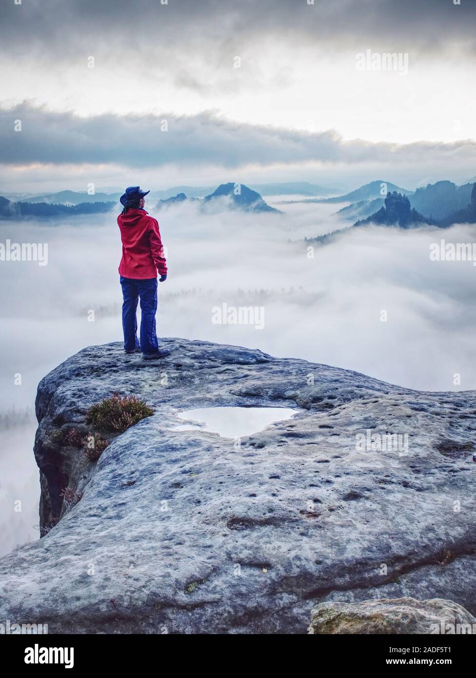 Woman watching sunrise over Himalayas, misty mountains National Park Stock Photo