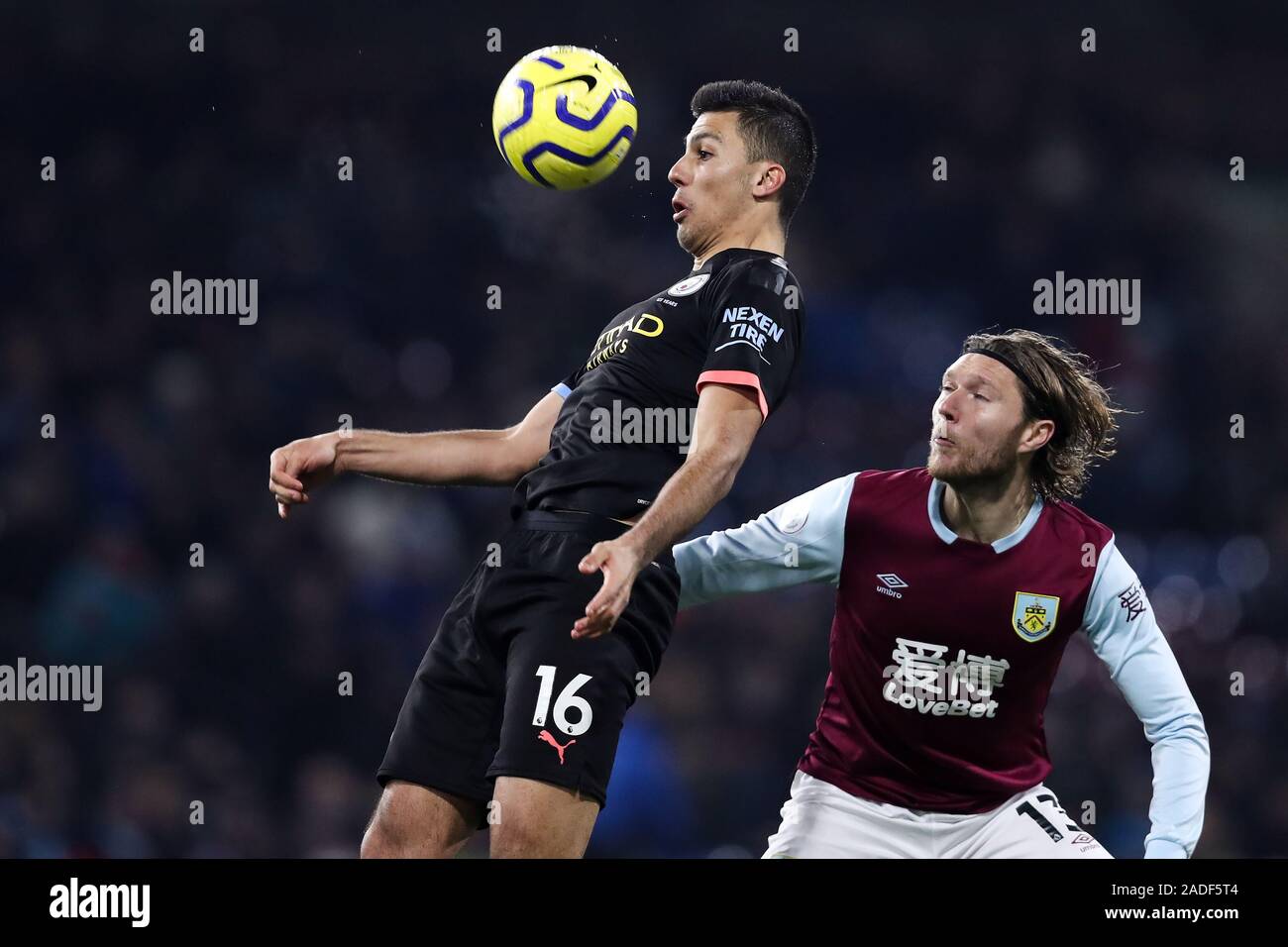 BURNLEY, ENGLAND - DECEMBER 03: Rodri (L) of Manchester City heads the ball away from Jeff Hendrick of Burnley during the Premier League match between Burnley FC and Manchester City at Turf Moor on December 3, 2019 in Burnley, United Kingdom. (Photo by MB Media) Stock Photo