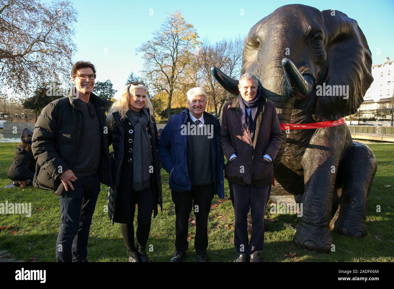 Marble Arch. London, UK 4 Dec 2019 - Artists Marc (L), Gillie (2nd from left), Author and father of the Prime Minister Boris Johnson, Stanley Johnson, (2nd from Right) and Parliamentary Conservative candidate for Richmond Park and North Kingston and former Tory candidate for Mayor of London Zac Goldsmith (R) pose with a bronze elephant during the unveiling of life-sized herd of 21 bronze elephants at Marble Arch. at Marble Arch. Credit: Dinendra Haria/Alamy Live News Stock Photo