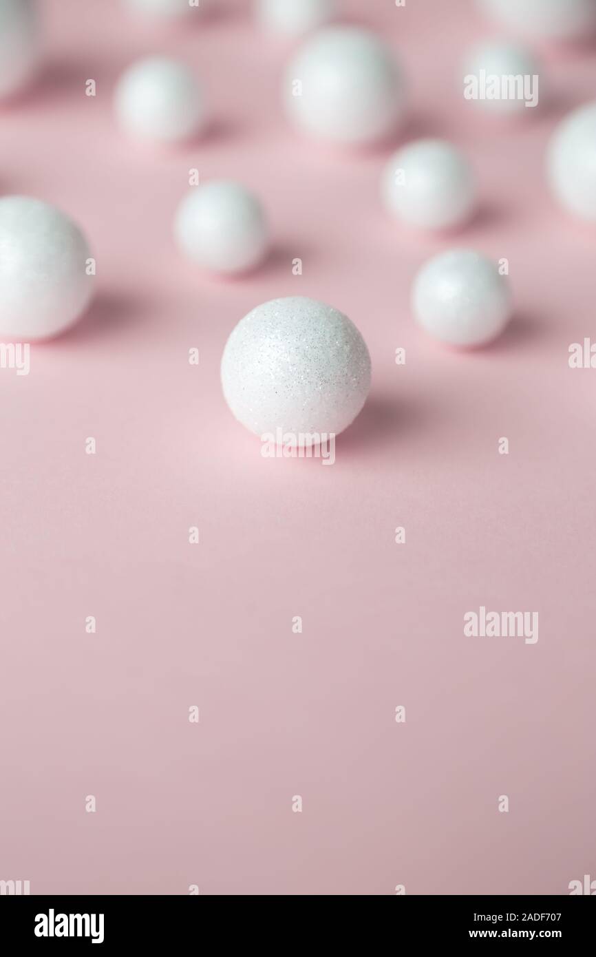 Bubbles made of styrofoam balls on pastel pink background minimal creative concept. Space for copy. Stock Photo