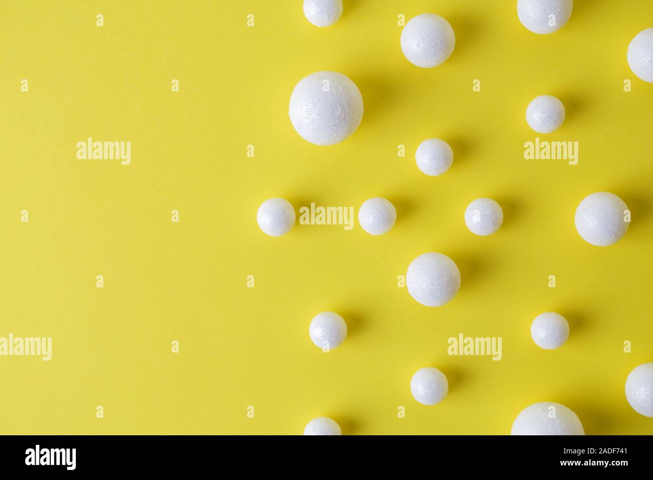 Bubbles made of styrofoam balls on yellow background minimal creative concept. Stock Photo