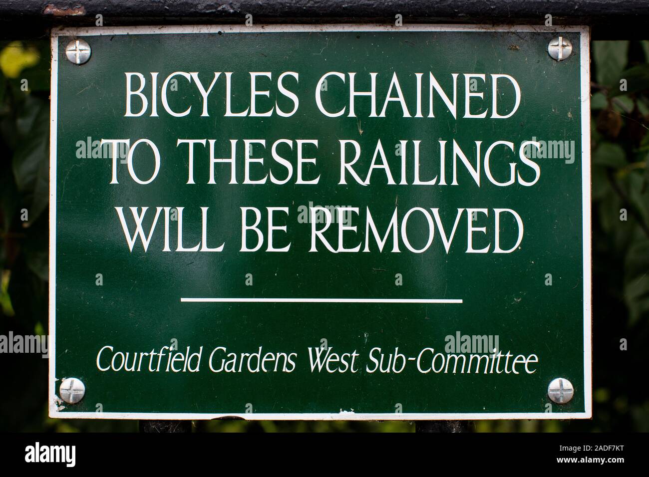 Sign prohibiting bicycles railings of Courtfield Gardens West, Kensington, London Stock Photo