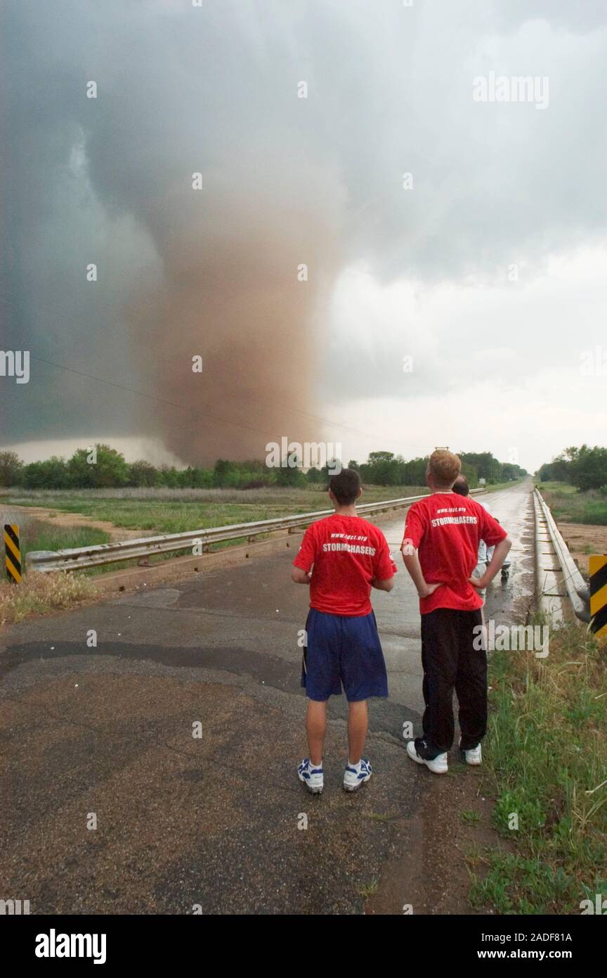 Tornado. Stormchasers watching a tornado move over farmland. A tornado