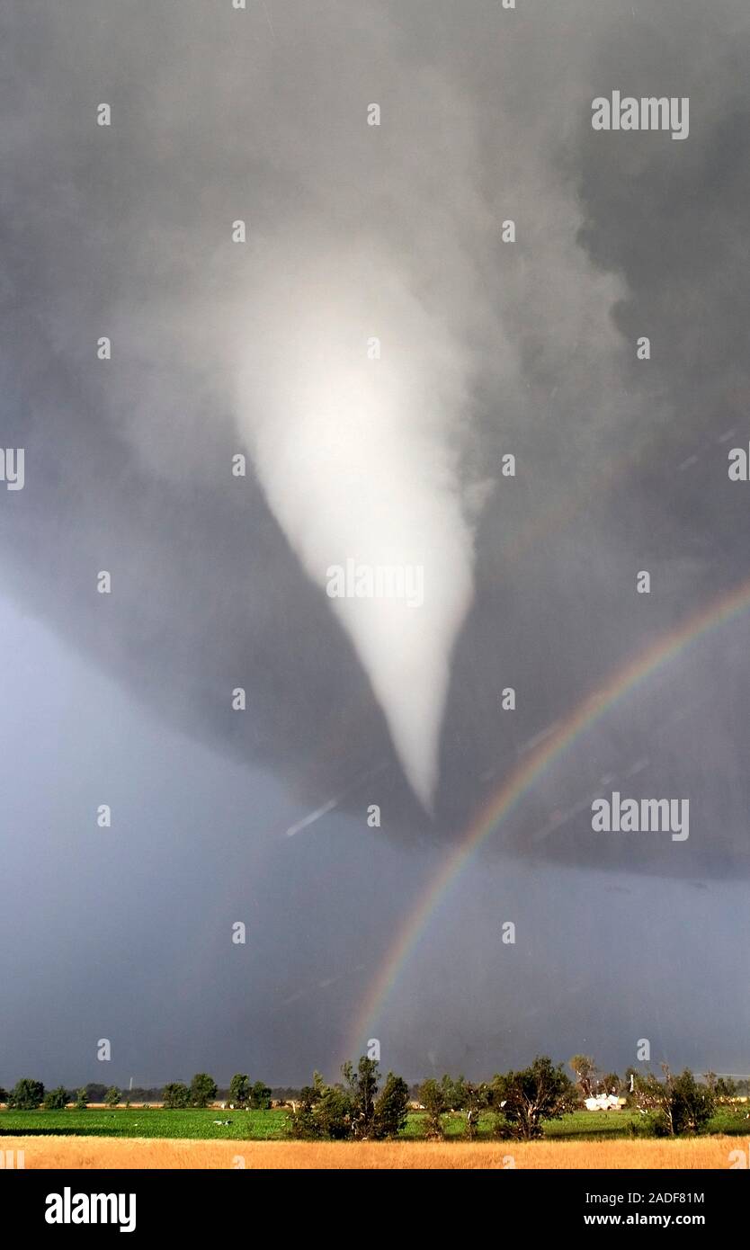 Tornado with a rainbow forming near the base of its funnel. The white