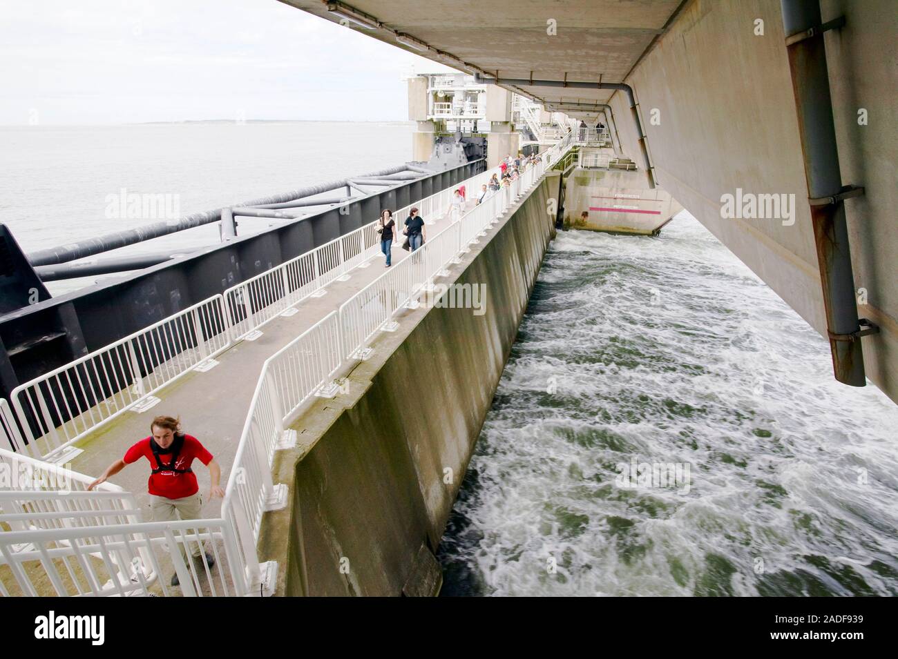 Tourists on a flood barrier in Zeeland, Netherlands. This is part of ...