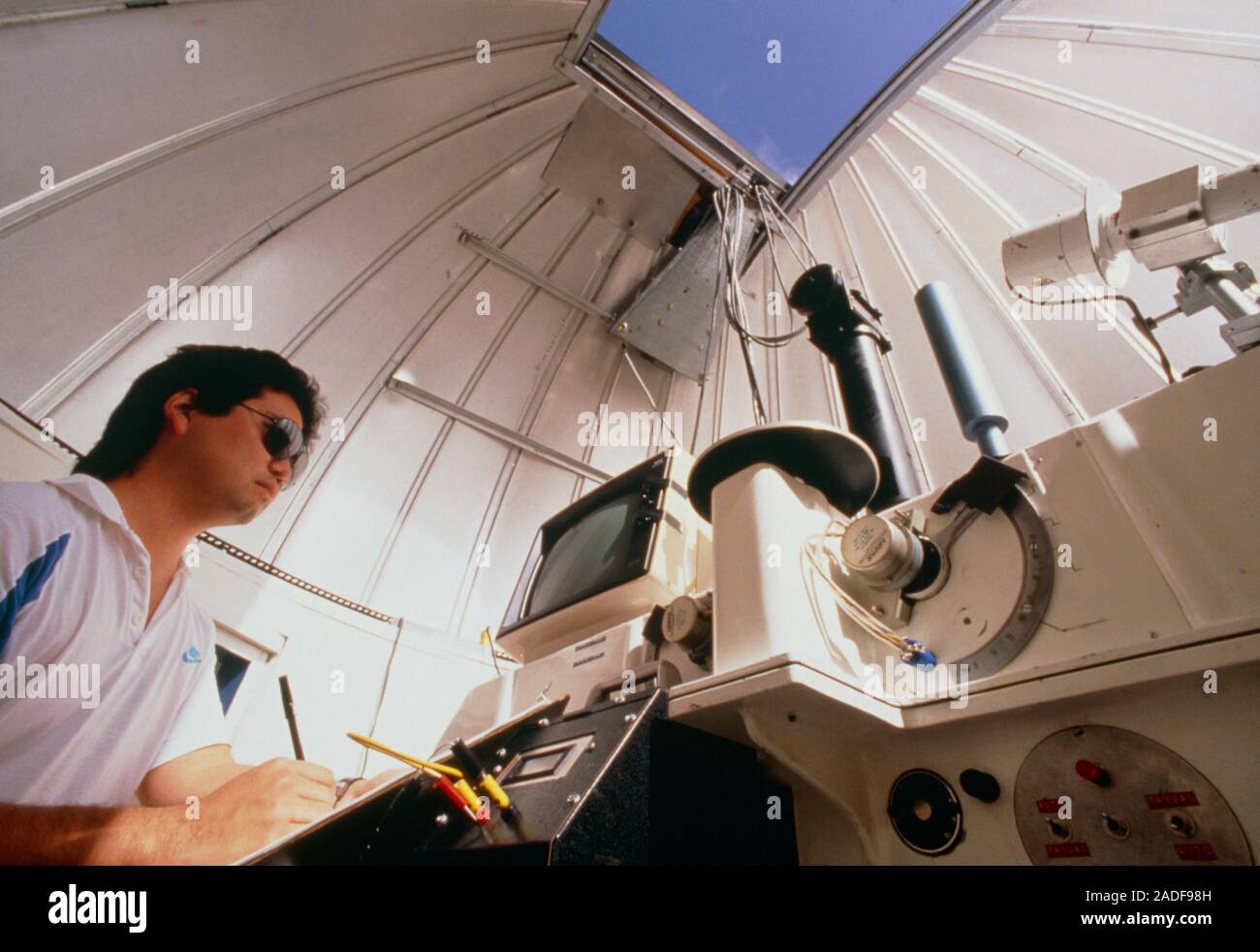 Measuring the ozone layer. A researcher making notes next to a Dobson