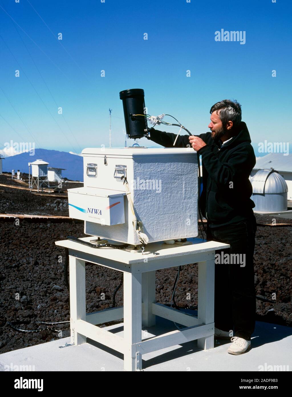 Ultraviolet monitor. Scientist uses a light source to calibrate a