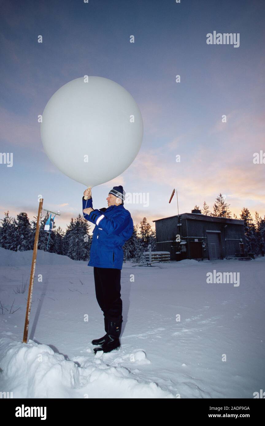 MODEL RELEASED. Weather balloon. Meteorologist launching a weather
