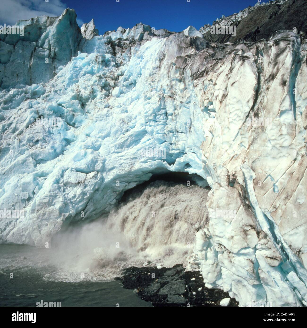 Glacial meltwater outlet cave. View of meltwater flooding out of a cave ...