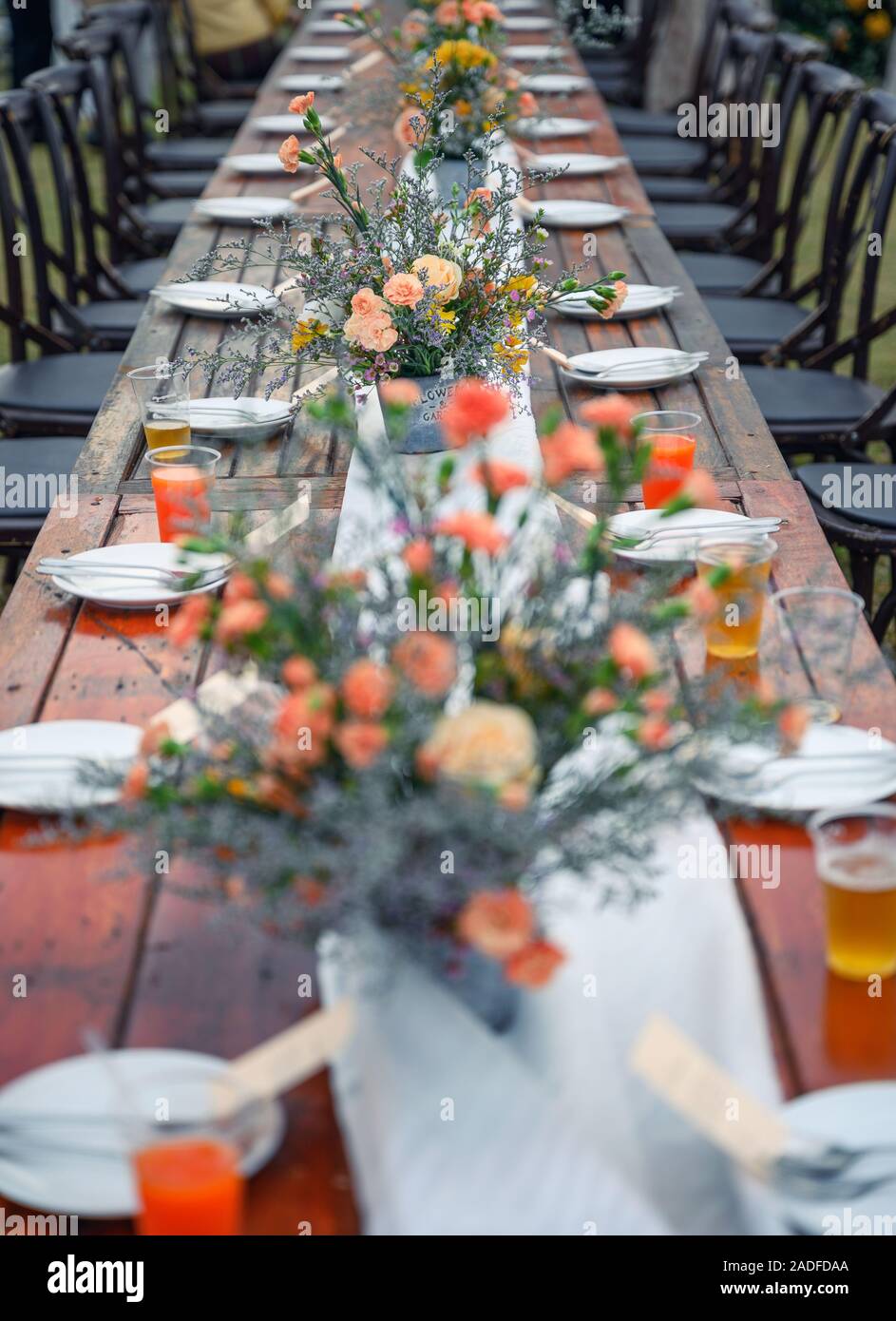 Rustic wedding style, Wooden dining table with flowers decoration and ...