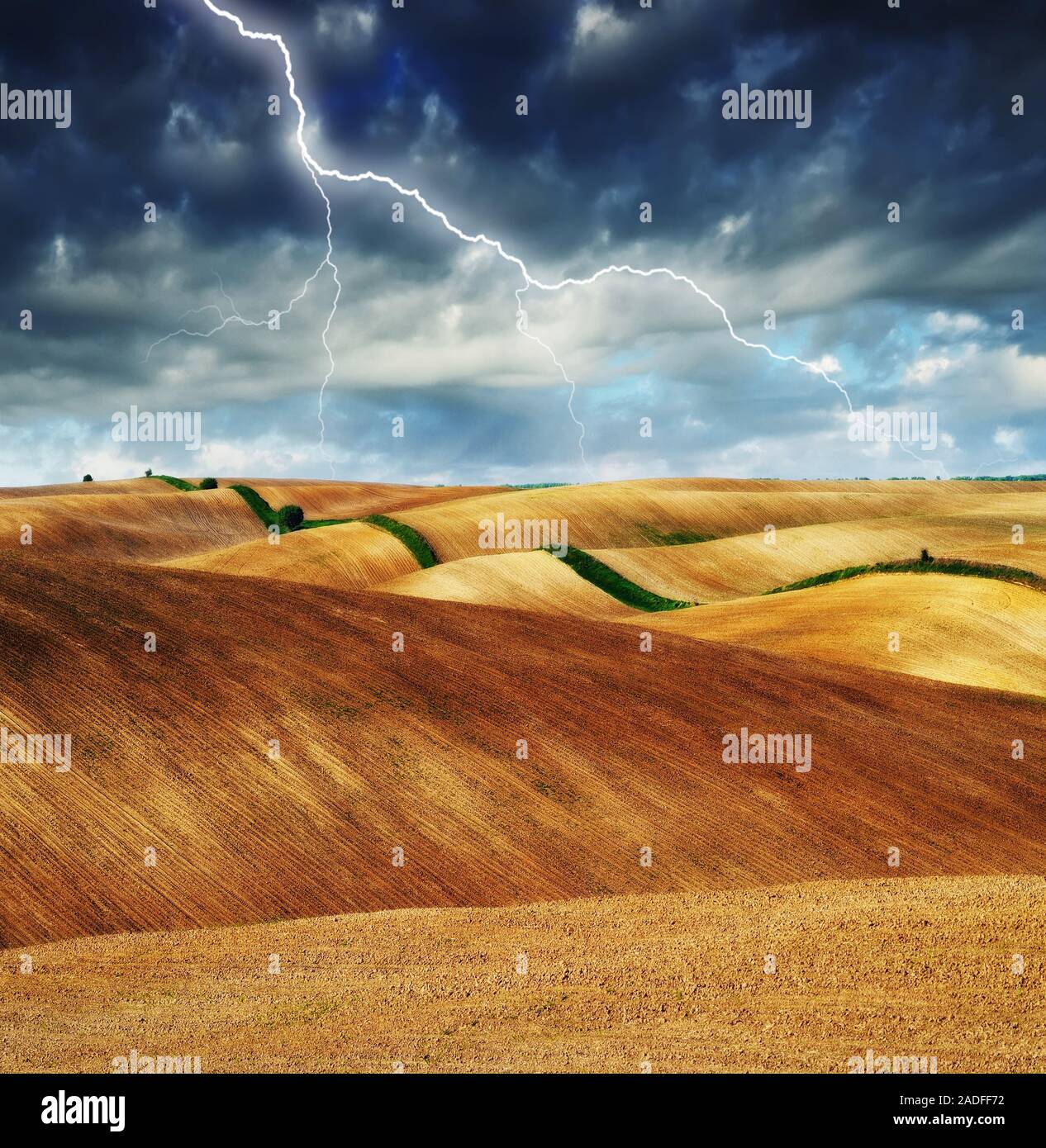 lightning over the field. picturesque hilly field Stock Photo Alamy