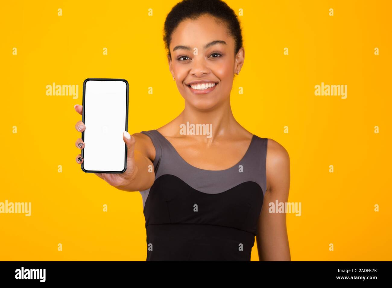 Fit Black Girl Showing Phone Blank Screen Standing, Yellow Background Stock  Photo - Alamy