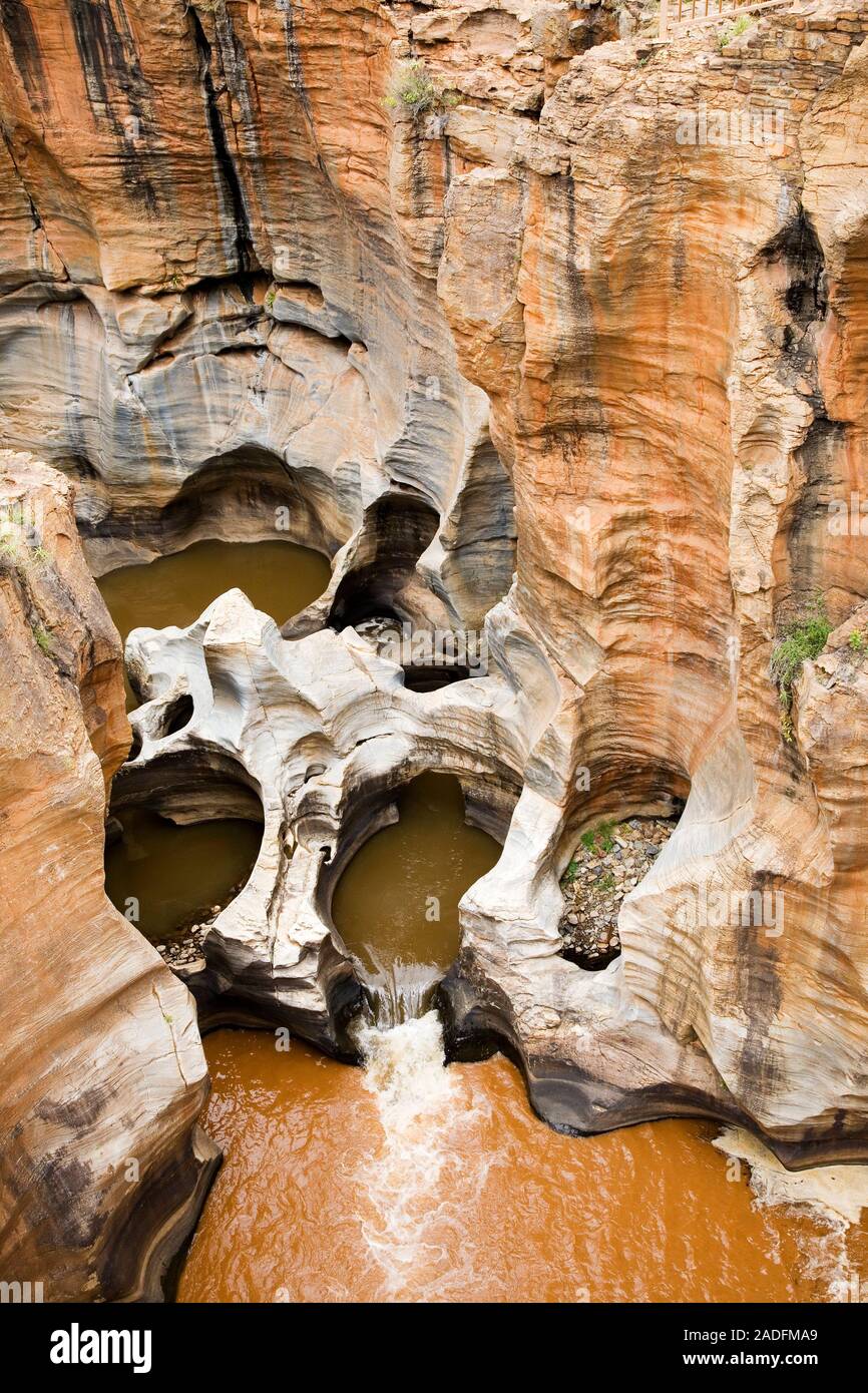 Eroded sandstone potholes. These holes in the red sandstone rock are