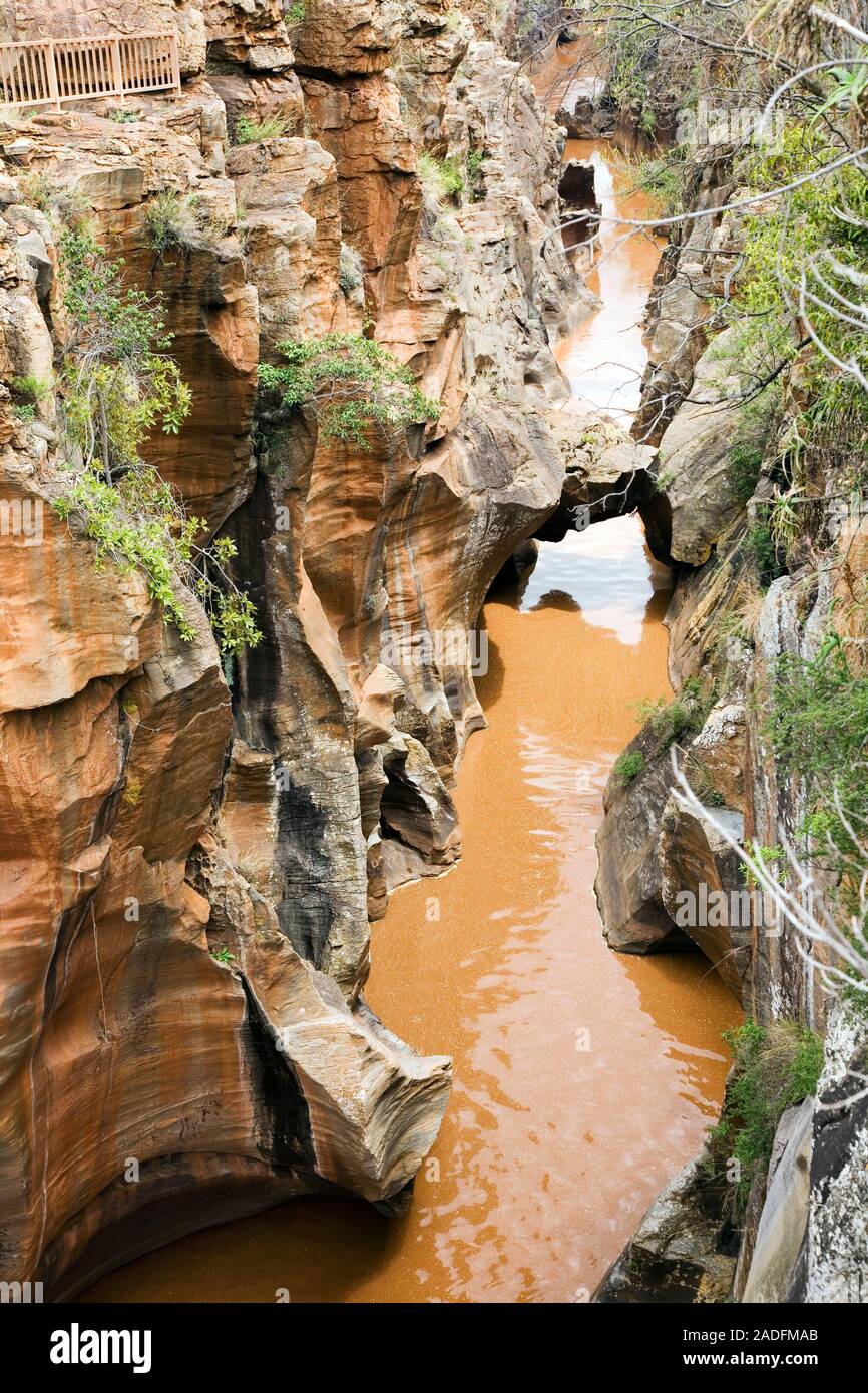 Eroded sandstone potholes. These holes in the red sandstone rock are